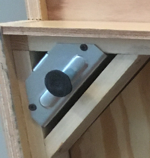 Picture of the leveling foot from the bottom of the cabinet.